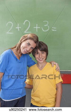 The teacher giving a hug to her pupil View Large Photo Image Stock Image - The teacher giving a hug to her pupil. Fotosearch