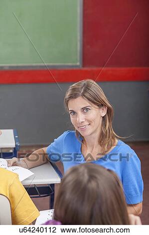 The teacher looking at camera View Large Photo Image Stock Image - The teacher looking at camera. Fotosearch