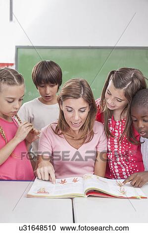 Stock Image - The teacher reading a book. Fotosearch