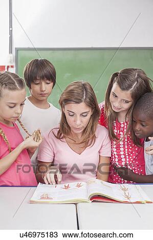 The teacher reading a book View Large Photo Image Stock Image - The teacher reading a book. Fotosearch