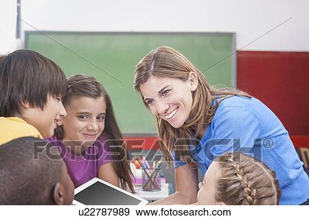 The teacher showing something View Large Photo Image Stock Photo - The teacher showing something. Fotosearch