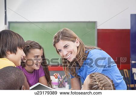 Stock Photo - The teacher showing something. Fotosearch