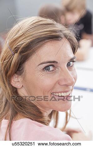 The teacher smiling and looking at camera View Large Photo Image Stock Image - The teacher smiling and looking at camera. Fotosearch