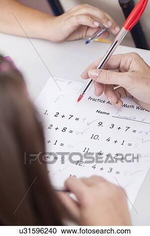 the teacher teaching and checking the homework View Large Photo Image Stock Image - the teacher teaching and checking the homework. Fotosearch
