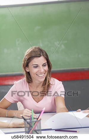 Picture - The teacher teaching and smiling. Fotosearch