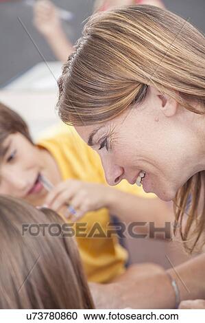 Stock Image - The teacher teaching and smiling. Fotosearch