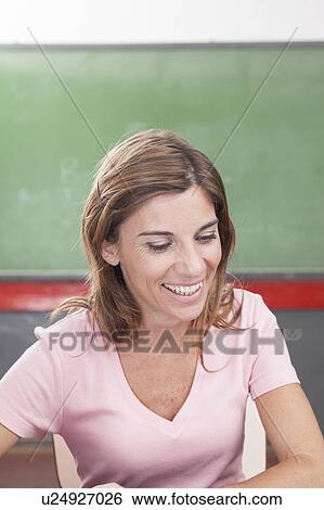 Stock Photograph - The teacher teaching and smiling. Fotosearch