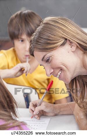 Stock Photograph - The teacher teaching and smiling. Fotosearch
