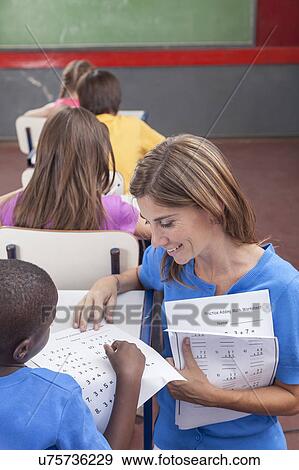 Stock Photo - The teacher teaching to pupil. Fotosearch