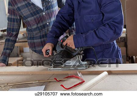 Stock Photo - Two carpenters working. Fotosearch