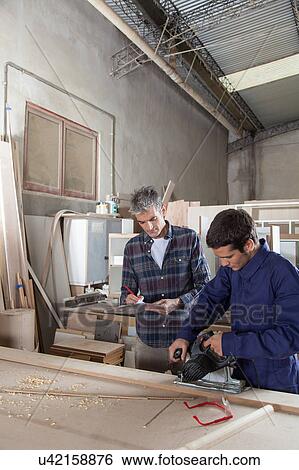 Two carpenters working View Large Photo Image Stock Photograph - Two carpenters working. Fotosearch