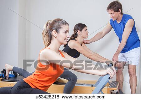 Two girls exercising in pilates View Large Photo Image Stock Photo - Two girls exercising in pilates. Fotosearch