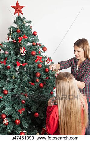 Woman and daugther son decorating the christmas tree View Large Photo Image Stock Image - Woman and daugther son decorating the christmas tree. Fotosearch