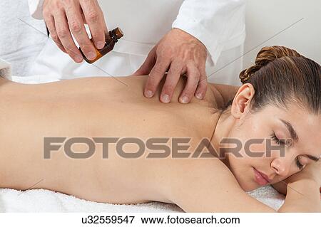 Woman gets a massage on her shoulders View Large Photo Image Stock Photo - Woman gets a massage on her shoulders. Fotosearch