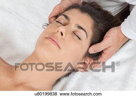 Stock Photo - Woman gets a massage with oil. Fotosearch