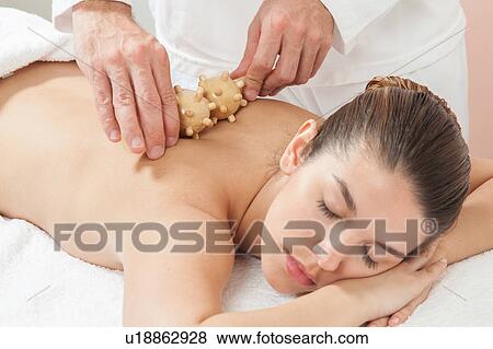 Stock Photo - Woman getting a massage with a special tool. Fotosearch