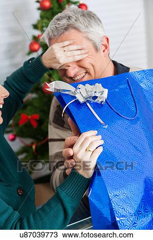 Woman giving her husband a surprise View Large Photo Image Stock Image - Woman giving her husband a surprise. Fotosearch