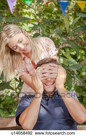 Woman giving to her boyfriend a surprise View Large Photo Image Stock Image - Woman giving to her boyfriend a surprise. Fotosearch