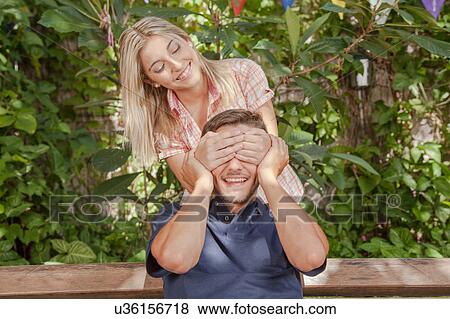 Woman giving to her boyfriend a surprise View Large Photo Image Stock Photo - Woman giving to her boyfriend a surprise. Fotosearch