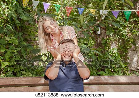 Woman giving to her boyfriend a surprise View Large Photo Image Stock Photo - Woman giving to her boyfriend a surprise. Fotosearch