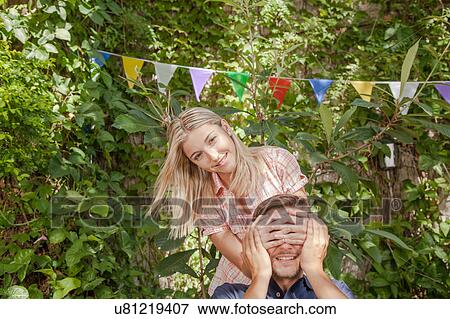 Woman giving to her boyfriend a surprise View Large Photo Image Stock Photo - Woman giving to her boyfriend a surprise. Fotosearch