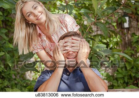 Woman giving to her boyfriend a surprise View Large Photo Image Stock Photograph - Woman giving to her boyfriend a surprise. Fotosearch