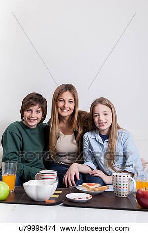 Woman having the breakfast with your sons View Large Photo Image Picture - Woman having the breakfast with your sons. Fotosearch