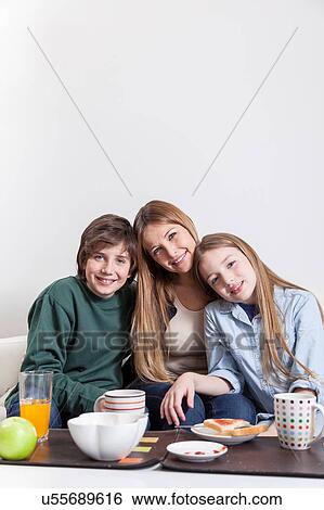 Woman having the breakfast with your sons View Large Photo Image Stock Photograph - Woman having the breakfast with your sons. Fotosearch