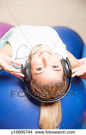 Woman listen to music in yoga class View Large Photo Image Picture - Woman listen to music in yoga class. Fotosearch