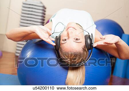 Woman listen to music in yoga class View Large Photo Image Stock Image - Woman listen to music in yoga class. Fotosearch