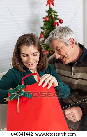 Woman open gift bag View Large Photo Image Stock Image - Woman open gift bag. Fotosearch