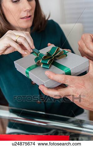 Woman opening the gift View Large Photo Image Picture - Woman opening the gift. Fotosearch