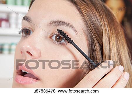 Woman putting on mascara View Large Photo Image Stock Photo - Woman putting on mascara. Fotosearch