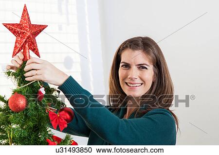 Woman putting together the christmas tree View Large Photo Image Stock Image - Woman putting together the christmas tree. Fotosearch