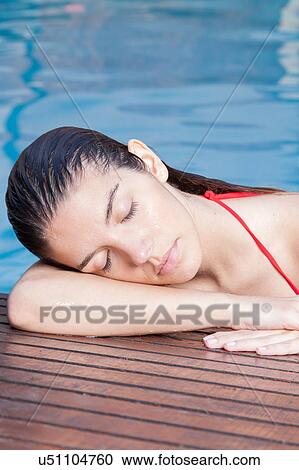 Woman resting in the edge of the pool View Large Photo Image Stock Image - Woman resting in the edge of the pool. Fotosearch