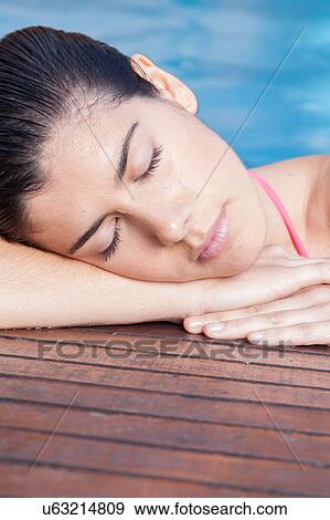 Stock Photo - Woman sleep in the pool. Fotosearch