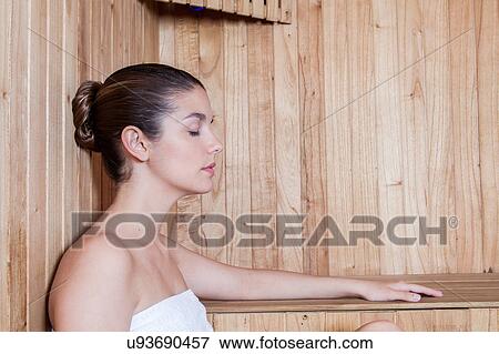 Stock Photo - Woman sleep inside the sauna. Fotosearch
