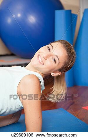 Stock Photograph - Woman smiling in yoga. Fotosearch