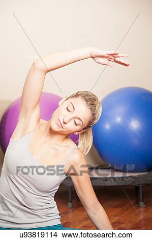 Woman stretching in yoga View Large Photo Image Picture - Woman stretching in yoga. Fotosearch
