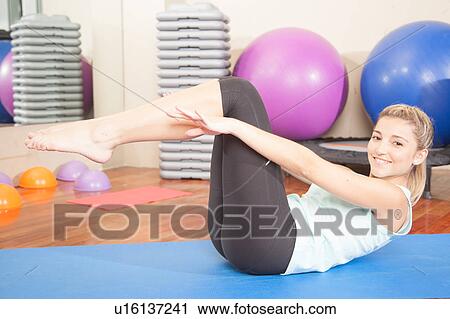 Stock Image - Woman stretching in yoga. Fotosearch