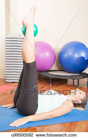 Stock Image - Woman stretching in yoga. Fotosearch