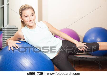 Woman stretching with a ball View Large Photo Image Stock Image - Woman stretching with a ball. Fotosearch