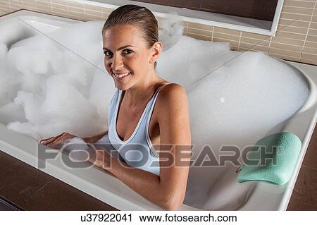 Stock Image - woman taking a shower. Fotosearch