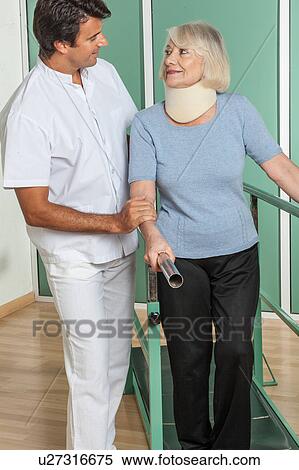 Stock Photography - Woman using a orthopedic neck. Fotosearch