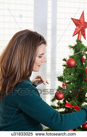 Woman with a christmas tree View Large Photo Image Stock Photography - Woman with a christmas tree. Fotosearch