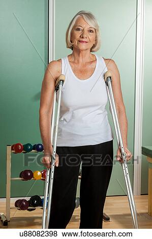 Woman with a neck brace using crutches View Large Photo Image Stock Photo - Woman with a neck brace using crutches. Fotosearch