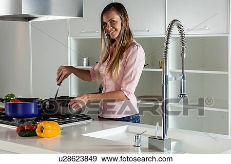 Stock Photo - women cooking with vegetables. Fotosearch