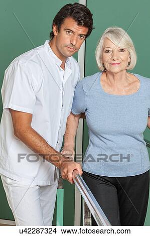 Picture - Women rehabilitating her legs with his doctor. Fotosearch