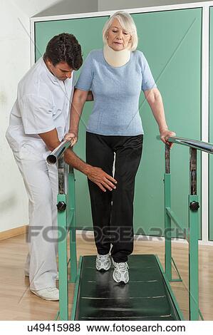Stock Photo - women rehabilitating her legs with his doctor. Fotosearch