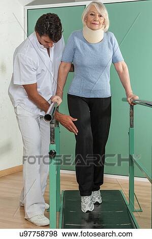 Stock Photo - women rehabilitating her legs with his doctor. Fotosearch